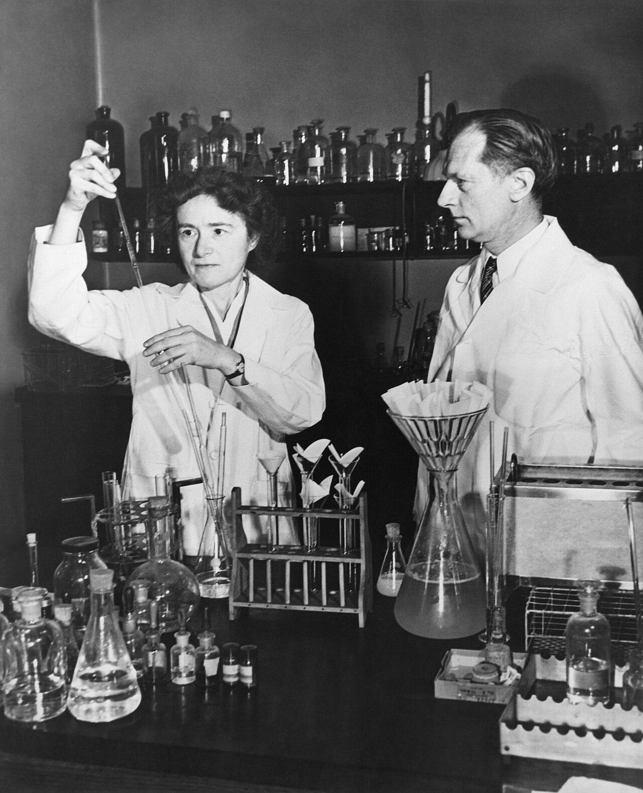 Historic laboratory photograph of two researchers working with glassware
